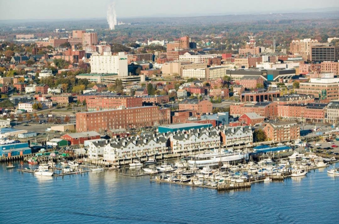 The scenic waterfront of Portland, Maine, with boats docked in the harbor.