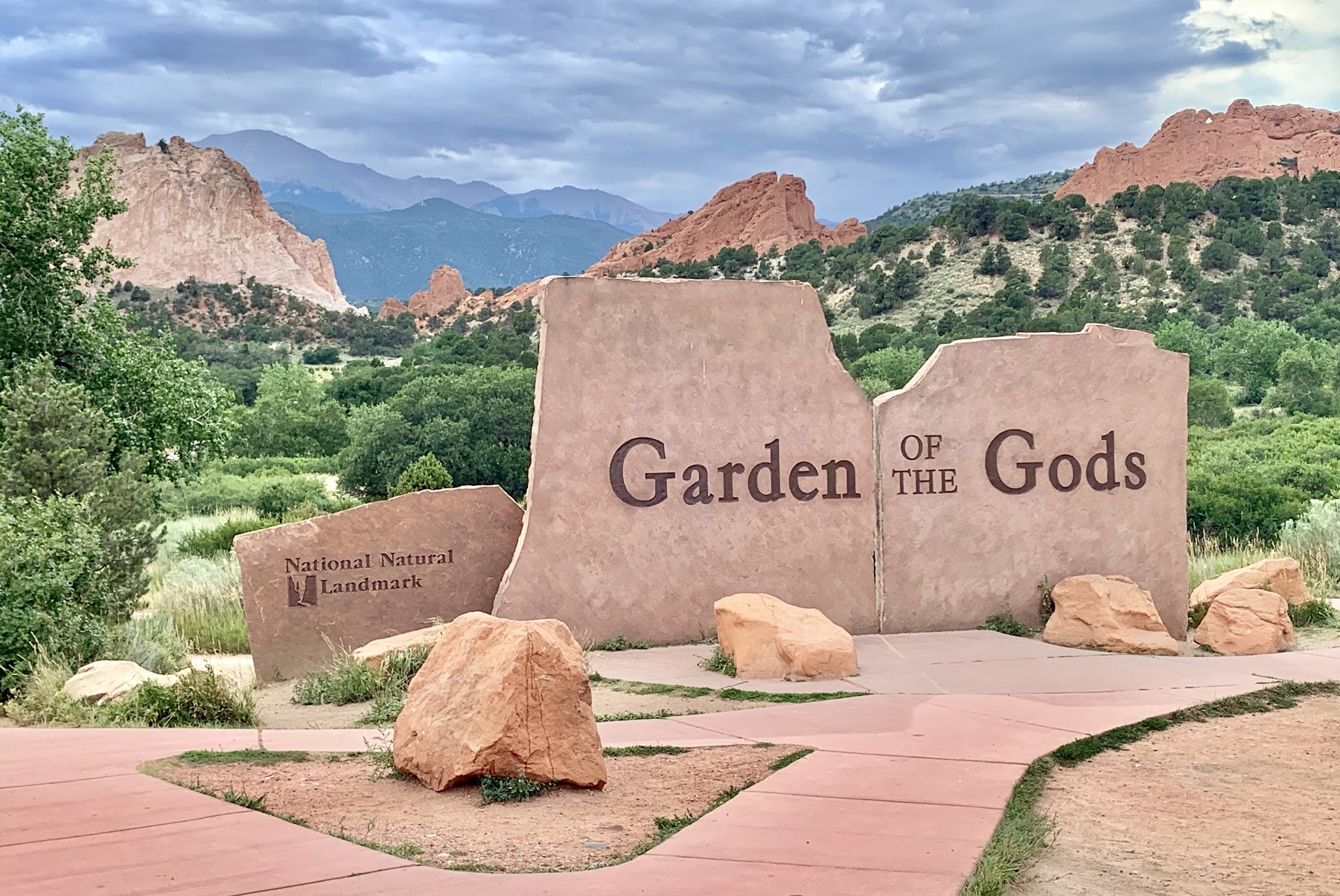 The iconic red rock formations of Garden of the Gods stand out against a clear blue sky.