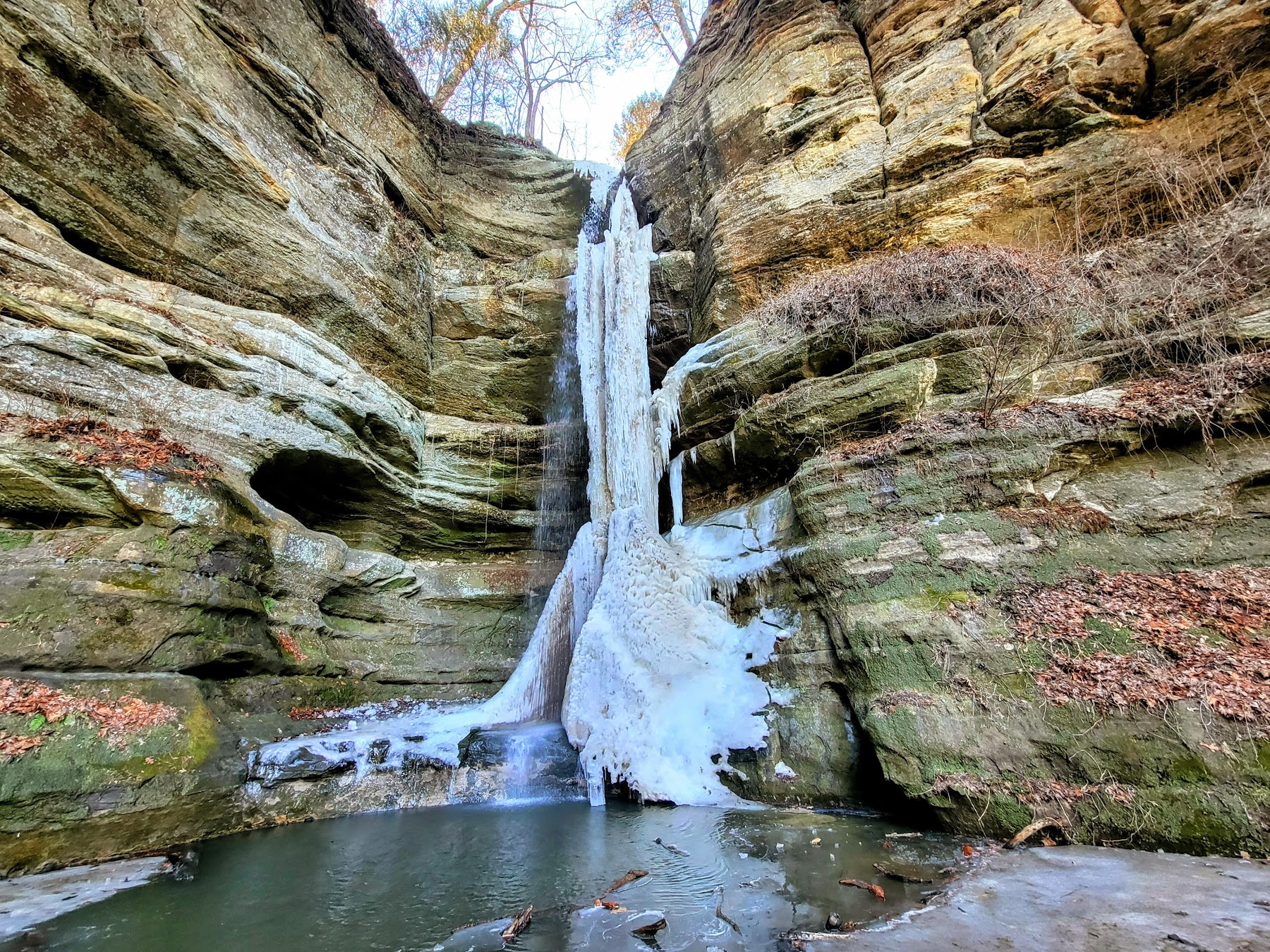 Water cascading over a rock ledge into a canyon at Starved Rock State Park.