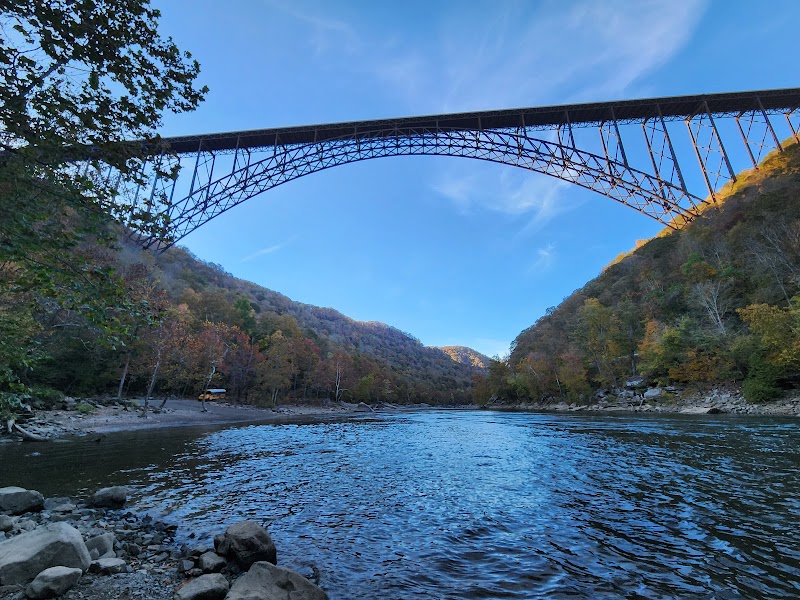 The iconic New River Gorge Bridge surrounded by early spring foliage.